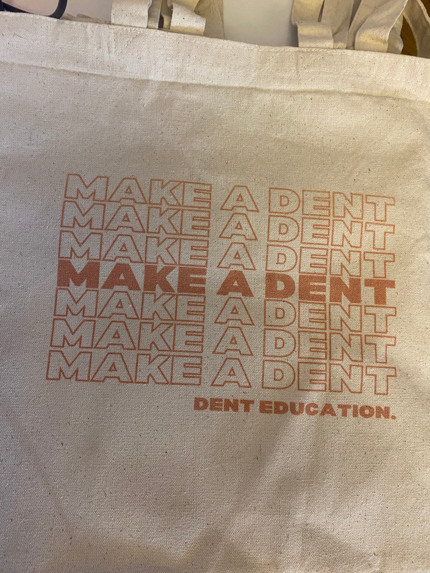 'Make A Dent' Beige Tote Bag