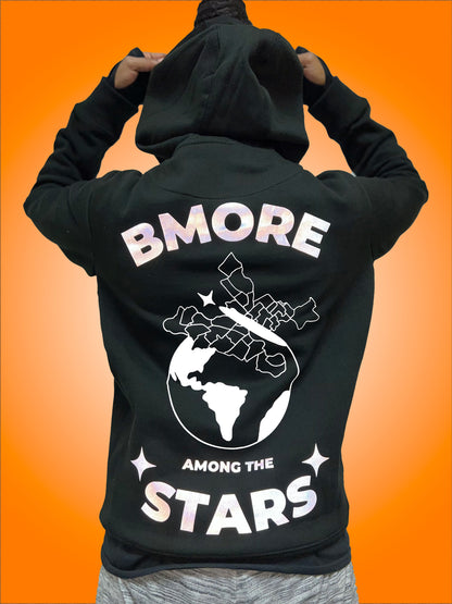 Back of  black hoodie. In reflective, gray, shimmering  vinyl: "BMore" written in curved down, bold letters at top, "Among the", written along the bottom over Stars which is slightly curved up, bold letters the same size as "Bmore". 2  stars on the outside of the word "Stars". The lettering and stars are all in reflective gray vinyl that shimmered. In between is the "Black Butterfly", a design which has West & East Baltimore neighborhoods outlined, sitting on top of the world 